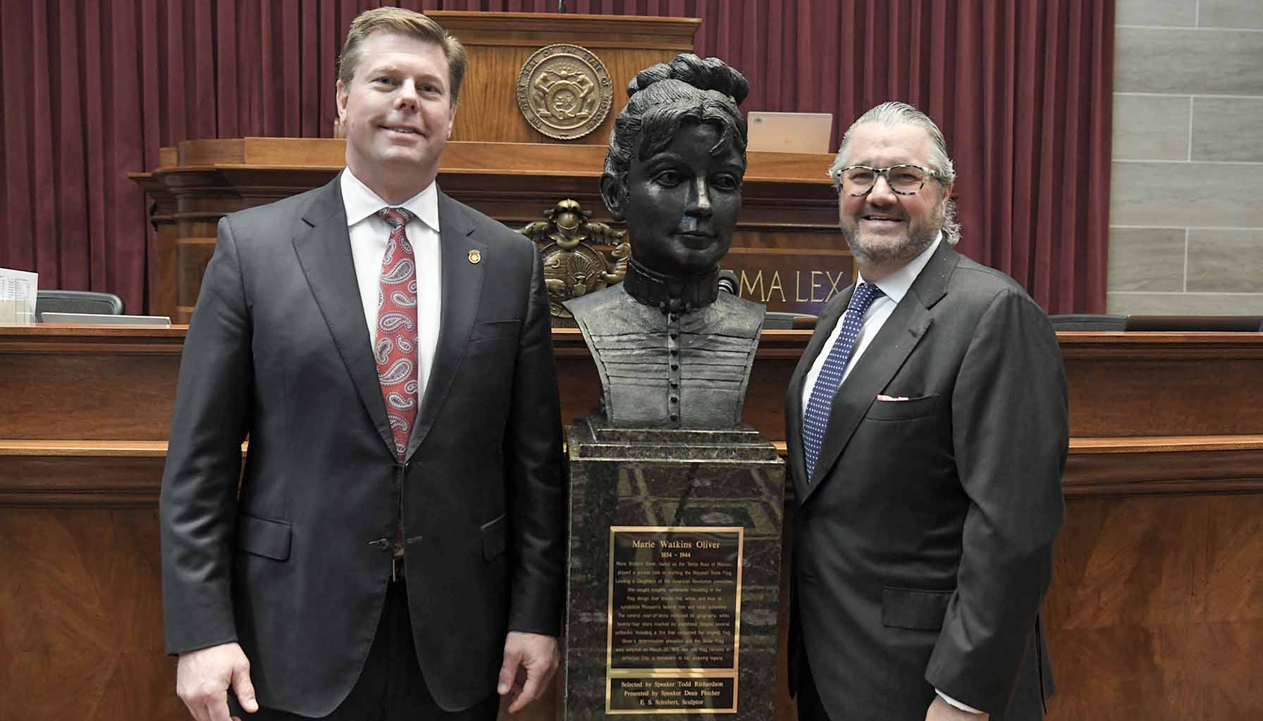 Missouri House Speaker Dean Plocher stands alongside the newly unveiled bust of Marie Watkins Oliver with her great-great grandson Jack Oliver